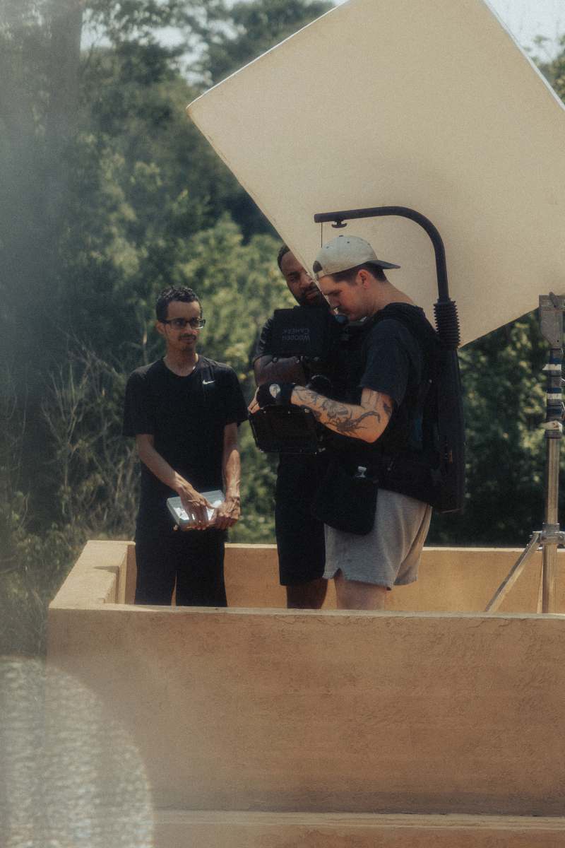 short films man in black crew neck t-shirt holding black dslr camera desert